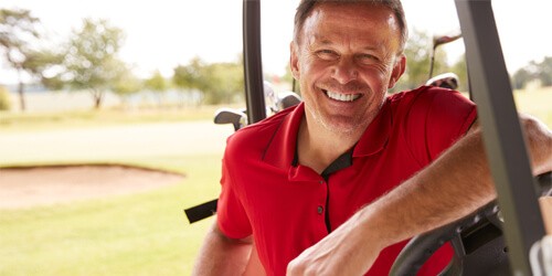 man driving golf cart