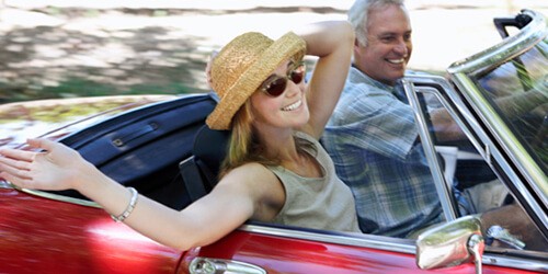couple driving in classic car